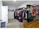 Walk-in closet with clothes, shelving, and carpeted floor at 4221 Millersville Rd, Indianapolis, IN 46205