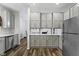 Well-lit kitchen boasting white cabinets, stainless steel appliances, and elegant countertops at 4221 Millersville Rd, Indianapolis, IN 46205