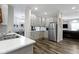 Bright kitchen featuring stainless steel appliances, gray cabinets, and an open layout to the living area at 4221 Millersville Rd, Indianapolis, IN 46205