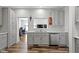 Bright kitchen features stainless steel appliances and gray cabinets with modern fixtures at 4221 Millersville Rd, Indianapolis, IN 46205