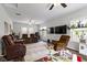 Large living room with multiple seating areas, two televisions and natural light from the windows at 4221 Millersville Rd, Indianapolis, IN 46205