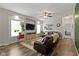Bright and airy living room with a large television, hardwood floors, and a comfortable sectional sofa at 4221 Millersville Rd, Indianapolis, IN 46205