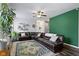 Spacious living room featuring a large sectional sofa, decorative rug, and hardwood floors at 4221 Millersville Rd, Indianapolis, IN 46205