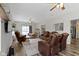 Spacious living room features multiple seating options, ceiling fans and natural light at 4221 Millersville Rd, Indianapolis, IN 46205