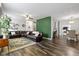 Spacious living room featuring a large sectional sofa, decorative rug, and hardwood floors at 4221 Millersville Rd, Indianapolis, IN 46205