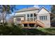 Brick home exterior, showcasing a wood deck with stairs and large windows at 452 Twin Oaks Dr, Carmel, IN 46032