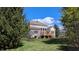 Backyard of brick home exterior featuring a wood deck and ample green space at 452 Twin Oaks Dr, Carmel, IN 46032