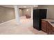 The finished basement features neutral carpet, a kitchenette with a black fridge and sink, offering convenience and style at 452 Twin Oaks Dr, Carmel, IN 46032