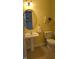 Cozy half bathroom with a pedestal sink, toilet, and tile flooring at 452 Twin Oaks Dr, Carmel, IN 46032