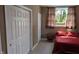 Bedroom with a window providing natural light with red furnishings and a built in bench along the wall at 452 Twin Oaks Dr, Carmel, IN 46032