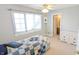 Cozy bedroom with a twin bed, large window, white dresser, and en-suite bathroom at 452 Twin Oaks Dr, Carmel, IN 46032