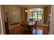 Dining room with a chandelier, hardwood floors, and large windows overlooking the backyard at 452 Twin Oaks Dr, Carmel, IN 46032