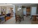 Open-concept dining area featuring a glass table, wooden chairs, and easy access to other living spaces at 452 Twin Oaks Dr, Carmel, IN 46032