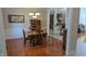 Traditional dining room with hardwood floors, a wooden table, and access to other living areas at 452 Twin Oaks Dr, Carmel, IN 46032