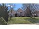 Charming brick two-story home featuring a well-manicured lawn and arched entryway at 452 Twin Oaks Dr, Carmel, IN 46032