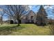 Charming two-story home with brick exterior, well-manicured lawn, and mature trees at 452 Twin Oaks Dr, Carmel, IN 46032
