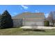 Three-car garage on a brick home with a basketball hoop, green grass and blue skies at 452 Twin Oaks Dr, Carmel, IN 46032
