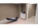 Finished basement workout area includes space for gym equipment and a storage cabinet perfect for a home gym at 452 Twin Oaks Dr, Carmel, IN 46032