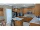 A kitchen featuring wood cabinets, stainless steel appliances, an island with granite countertops, and tiled floors at 452 Twin Oaks Dr, Carmel, IN 46032
