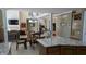 Open-concept space with dining area and kitchen featuring a living room fireplace, hardwood floors, and neutral colors at 452 Twin Oaks Dr, Carmel, IN 46032
