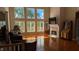 Bright living room boasts large windows, hardwood floors, and a cozy fireplace at 452 Twin Oaks Dr, Carmel, IN 46032