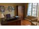 Well-lit office features hardwood floors, large window, and ample storage at 452 Twin Oaks Dr, Carmel, IN 46032