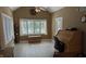 Bright office space with a vaulted ceiling, tile floor, and large windows overlooking the backyard at 452 Twin Oaks Dr, Carmel, IN 46032