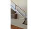 Elegant staircase with white railings, hardwood treads, and tiled landing at 452 Twin Oaks Dr, Carmel, IN 46032