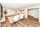 Open basement living space featuring wood-look flooring, a fireplace, and comfortable seating at 4625 Berkshire Ln, Indianapolis, IN 46226