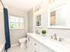 Bright bathroom featuring double sinks with marble countertops and updated fixtures at 4625 Berkshire Ln, Indianapolis, IN 46226