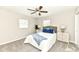 Cozy bedroom featuring a ceiling fan, two windows, and stylishly decorated bedside tables at 4625 Berkshire Ln, Indianapolis, IN 46226