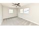 Neutral bedroom featuring two windows, a ceiling fan, and plush carpet at 4625 Berkshire Ln, Indianapolis, IN 46226