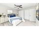 Bright bedroom with two closets, featuring a bed with blue pillows and a ceiling fan at 4625 Berkshire Ln, Indianapolis, IN 46226