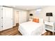 Cozy bedroom with sliding closet doors, wood floors, and accent lamps at 4625 Berkshire Ln, Indianapolis, IN 46226
