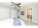 Bedroom with a view to the bathroom, featuring neutral colors, carpeted floor, and ceiling fan at 4625 Berkshire Ln, Indianapolis, IN 46226
