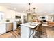 Bright kitchen features stainless steel appliances, large island with seating and views into the living room at 4625 Berkshire Ln, Indianapolis, IN 46226