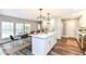Bright kitchen featuring an island with seating and adjacent dining area bathed in natural light at 4625 Berkshire Ln, Indianapolis, IN 46226