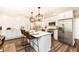 Bright kitchen features stainless steel appliances, large island with seating, and modern pendant lighting at 4625 Berkshire Ln, Indianapolis, IN 46226