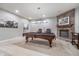 Finished basement featuring a pool table, brick fireplace, and neutral carpet at 519 Southwind, Brownsburg, IN 46112