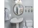 Charming bathroom with a pedestal sink, round mirror, and decorative wall hangings at 519 Southwind, Brownsburg, IN 46112