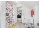 Bathroom features a floral shower curtain, toilet, and a view into an adjacent bedroom creating a connected space at 519 Southwind, Brownsburg, IN 46112