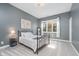 Bright bedroom featuring a metal bed frame, gray walls, and natural light at 519 Southwind, Brownsburg, IN 46112