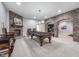 Basement game room features a fireplace, pool table, and brick arches, ideal for entertaining guests and relaxing at 519 Southwind, Brownsburg, IN 46112