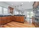Open kitchen with dark wood cabinets and stainless steel appliances at 519 Southwind, Brownsburg, IN 46112