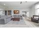 Open-concept living room features neutral carpet, a large sofa, and a view of the staircase at 519 Southwind, Brownsburg, IN 46112