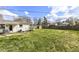 Spacious backyard showcasing lush lawn, shed, and privacy fence, perfect for outdoor activities and relaxation at 5849 Brouse Ave, Indianapolis, IN 46220