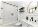 A modern bathroom with white subway tile, shower, and black fixtures at 5849 Brouse Ave, Indianapolis, IN 46220
