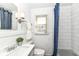 Bright, clean bathroom with a vanity, commode, and shower featuring a blue curtain at 5849 Brouse Ave, Indianapolis, IN 46220