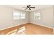 Sunlit bedroom with hardwood floors and a ceiling fan at 5849 Brouse Ave, Indianapolis, IN 46220