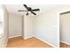 Neutral bedroom featuring hardwood flooring, ceiling fan, and ample natural light at 5849 Brouse Ave, Indianapolis, IN 46220
